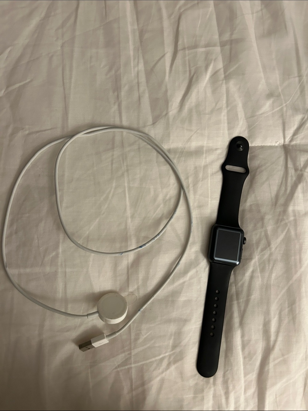 Apple Black Smartwatch with White Magnetic Charger